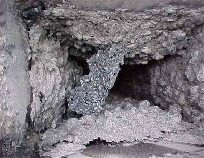 A close-up of heavy creosote buildup inside a chimney